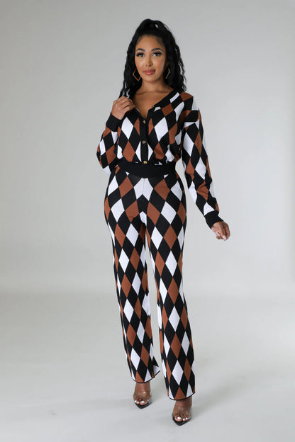 Woman wearing a black, white, and brown checkered jumpsuit on a gray background