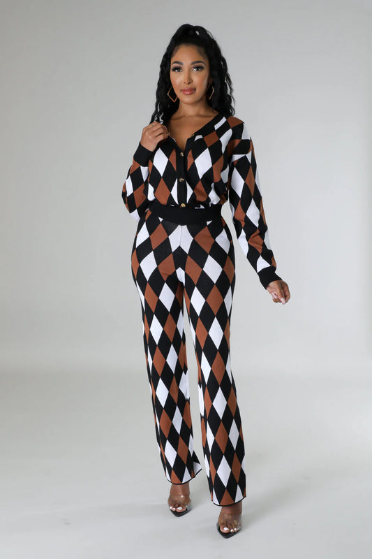 Woman wearing a black, white, and brown checkered jumpsuit on a gray background