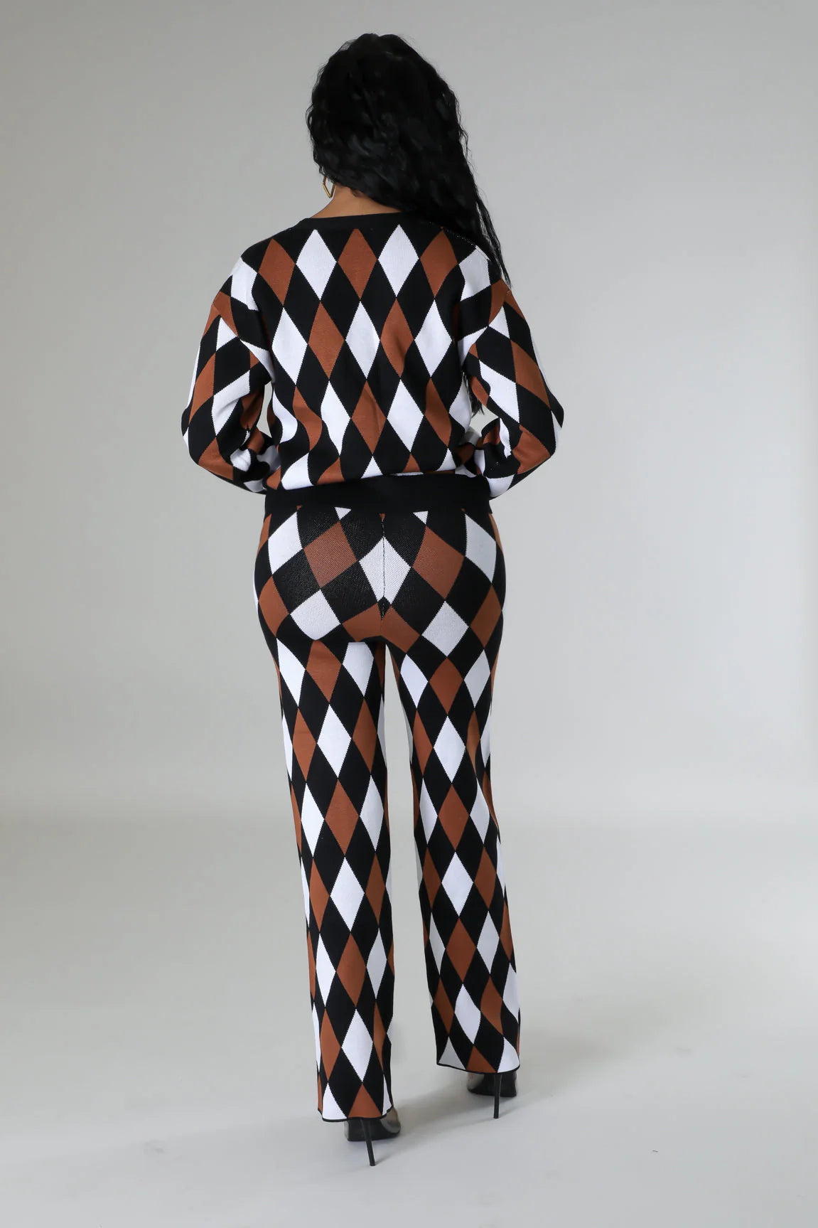 person wearing a black, white, and brown checkered outfit on a plain background