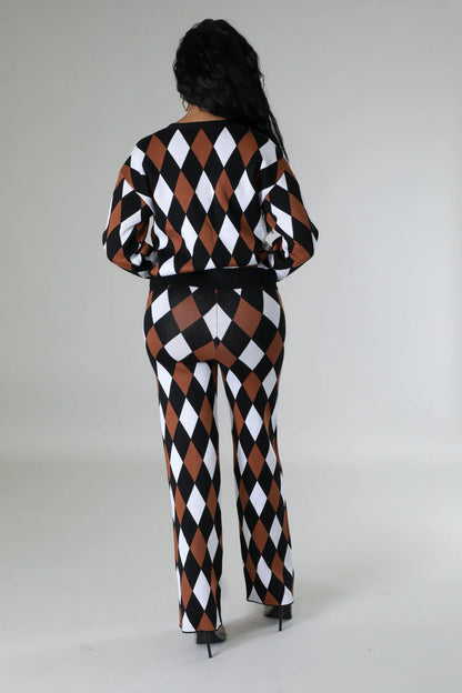 Person wearing a black, white, and brown checkered outfit on a plain background